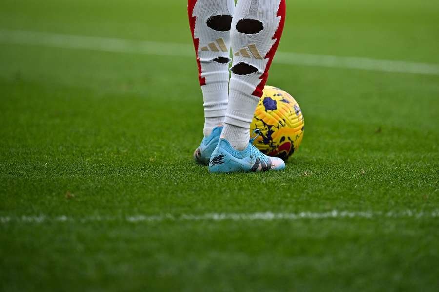 Why do footballers cut holes in their socks?